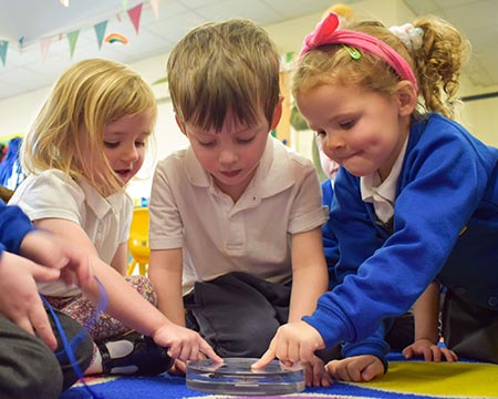 Pupils at Settle Primary School examine pieces of moon rock