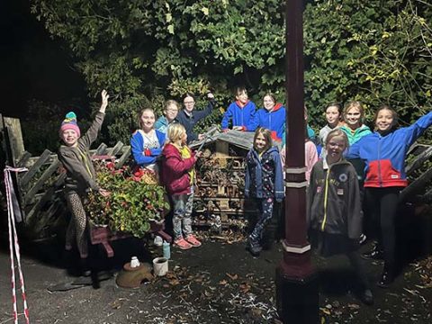 Girlguiding group at Settle Station with their bug hotel.
